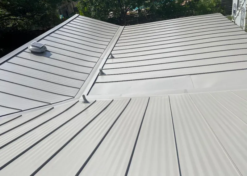 Solar attic fan installed on a metal roof for Roof Ventilation in Lutz